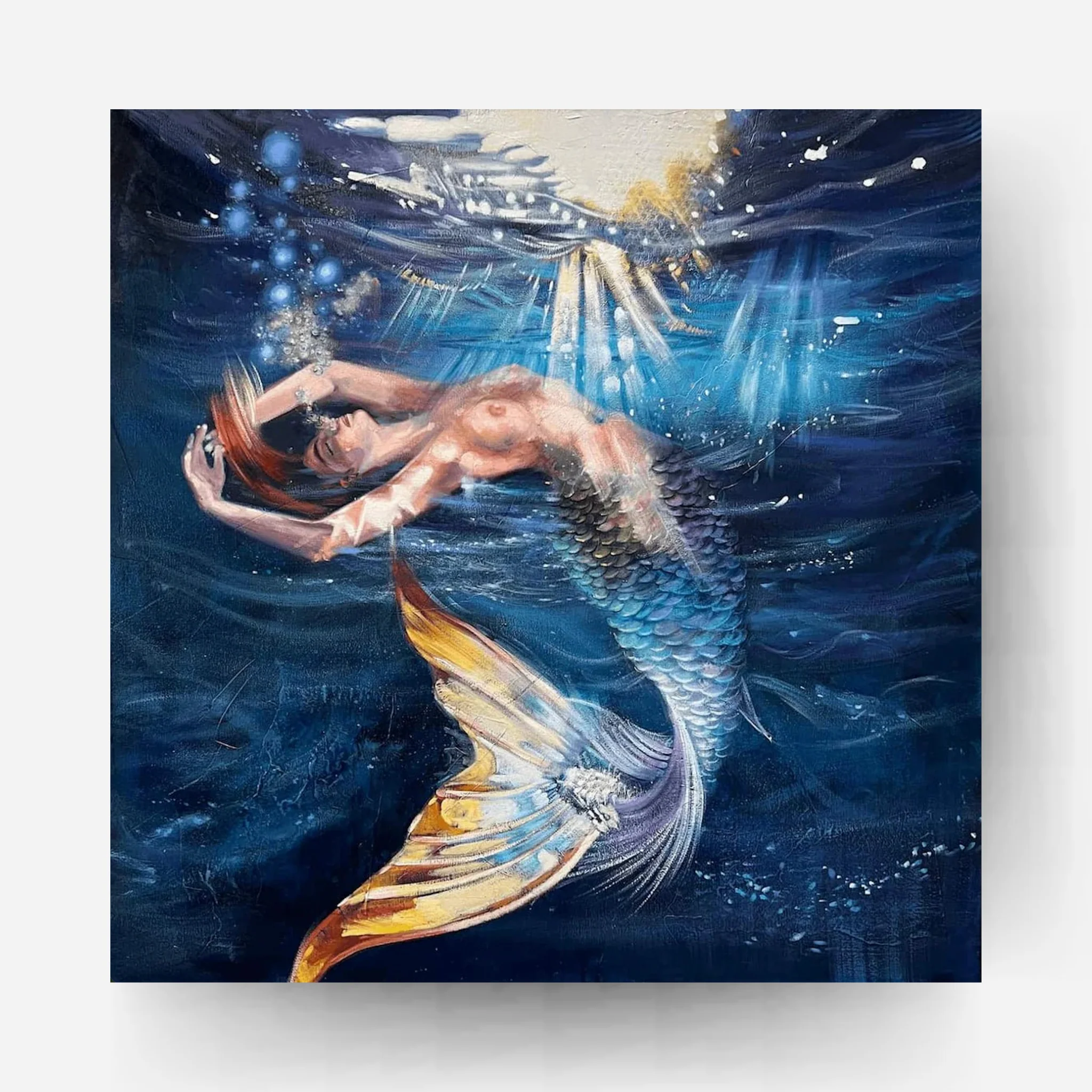 Mermaid floating in deep blue underwater light